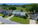 Inviting single-story home with manicured lawn, pond view, and mature trees in a serene community at 8832 Sw 108Th St, Ocala, FL 34481