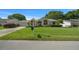 Single-story home with a pristine lawn and lush landscaping at 8832 Sw 108Th St, Ocala, FL 34481