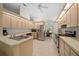 Bright kitchen with stainless steel appliances, light wood cabinets, and tile flooring at 8832 Sw 108Th St, Ocala, FL 34481