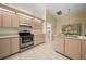 Kitchen showcasing light wood cabinetry, stainless steel appliances, and tile flooring at 8832 Sw 108Th St, Ocala, FL 34481