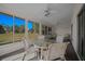 Bright sunroom with large windows offering views of the lush green landscape at 8832 Sw 108Th St, Ocala, FL 34481