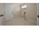 Practical laundry room with tile flooring, a window, and space for a washer and dryer at 8832 Sw 108Th St, Ocala, FL 34481