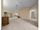 Spacious living room with vaulted ceilings, neutral paint, and sliding door access to the outdoors at 8832 Sw 108Th St, Ocala, FL 34481