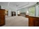 Spacious main bedroom featuring tray ceiling, neutral carpeting and multiple windows with great natural light at 8832 Sw 108Th St, Ocala, FL 34481