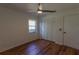 Cozy bedroom with wood flooring, a ceiling fan, closet and natural light from the windows at 9108 Sw 197Th Cir, Dunnellon, FL 34432