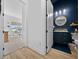 Stylish bathroom with dark blue walls, cabinetry, gold fixtures, and modern lighting at 8825 Sw 57Th Place Rd, Ocala, FL 34481