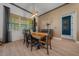 Elegant dining room with natural light boasts a wooden table, neutral walls, and modern decor at 8825 Sw 57Th Place Rd, Ocala, FL 34481