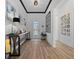 Inviting entryway with a console table, decorative mirror, artwork, and sleek hardwood floors at 8825 Sw 57Th Place Rd, Ocala, FL 34481