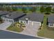 Beautiful single-story home showcasing a large driveway and a tranquil water view in a desirable neighborhood at 8825 Sw 57Th Place Rd, Ocala, FL 34481