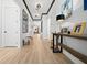 Elegant foyer with hardwood floors, designer lighting, and stylish decor creates an inviting ambiance at 8825 Sw 57Th Place Rd, Ocala, FL 34481