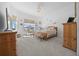 Bright main bedroom features large windows, a cozy sitting area, and a neutral color palette creating a peaceful retreat at 8825 Sw 57Th Place Rd, Ocala, FL 34481