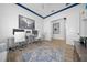 Bright office with a modern desk setup, blue accent molding, and a large area rug at 8825 Sw 57Th Place Rd, Ocala, FL 34481
