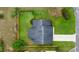 Aerial view of a well-maintained home with a lush, green lawn and fenced backyard at 1000 Woodward Oaks Cir, Eustis, FL 32726