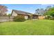 A view of a private backyard with lush greenery and a full wooden fence at 1000 Woodward Oaks Cir, Eustis, FL 32726