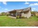 Spacious backyard featuring a screened patio with outdoor seating, ideal for relaxation at 1000 Woodward Oaks Cir, Eustis, FL 32726