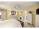 Inviting bedroom with light yellow walls, tile floors, and a fireplace at 1000 Woodward Oaks Cir, Eustis, FL 32726