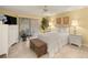 Bright bedroom with tile floors, a large window, and a comfortable bed at 1000 Woodward Oaks Cir, Eustis, FL 32726