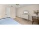 Bright bedroom with wood floors, a bed, and a vanity at 1000 Woodward Oaks Cir, Eustis, FL 32726