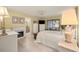 Well-lit bedroom featuring tile flooring, a large window, and a cozy bed with a bench at 1000 Woodward Oaks Cir, Eustis, FL 32726