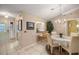 Inviting dining room with elegant chandelier, natural light, and views into the kitchen at 1000 Woodward Oaks Cir, Eustis, FL 32726