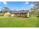 Charming single-story home with a well-maintained lawn and colorful landscaping at 1000 Woodward Oaks Cir, Eustis, FL 32726