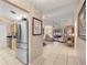Bright home hallway leading to a modern living room with stainless steel appliances at 1000 Woodward Oaks Cir, Eustis, FL 32726