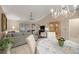 Open-concept living area with vaulted ceilings, tile flooring, and ample natural light at 1000 Woodward Oaks Cir, Eustis, FL 32726