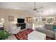 Open-concept living room with a fireplace, tile floors, and ample seating at 1000 Woodward Oaks Cir, Eustis, FL 32726