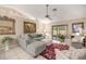 Bright living room with large windows, tile floors, and comfortable grey sectional sofa at 1000 Woodward Oaks Cir, Eustis, FL 32726