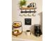 Charming coffee bar nook with coffee machine, donuts, cream, sugar, and coffee in decorative containers at 10076 Se 139Th Pl, Summerfield, FL 34491