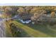 Aerial view of home on large lot with mature trees, green lawn and shed at 10495 Sw 100Th Ave, Ocala, FL 34481