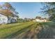 Large backyard with lush lawn and outbuildings, providing plenty of space for outdoor activities and potential landscaping projects at 10495 Sw 100Th Ave, Ocala, FL 34481