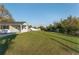 Expansive backyard with lush green grass, mature trees, and outbuildings offers ample space for outdoor activities and relaxation at 10495 Sw 100Th Ave, Ocala, FL 34481