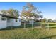 The backyard showcases a well-kept lawn, storage shed, and chain-link fence at 10495 Sw 100Th Ave, Ocala, FL 34481