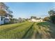View of large backyard with lush lawn and outbuildings, offering ample space for outdoor activities, gardening, and entertaining at 10495 Sw 100Th Ave, Ocala, FL 34481