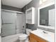 Updated bathroom features shower-tub combo with sliding glass doors and built-in storage at 10495 Sw 100Th Ave, Ocala, FL 34481