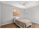 This bedroom features natural light from the window, ceiling fan and wood-look flooring at 10495 Sw 100Th Ave, Ocala, FL 34481