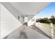 Covered carport area with a white picket fence, providing convenient parking and added charm at 10495 Sw 100Th Ave, Ocala, FL 34481