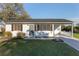 Charming single-story home features a covered carport and well-manicured front lawn at 10495 Sw 100Th Ave, Ocala, FL 34481
