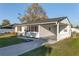 Inviting home featuring a covered carport and lovely landscaping, creating a welcoming entrance at 10495 Sw 100Th Ave, Ocala, FL 34481