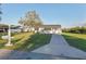 Attractive home with a long driveway and well-kept lawn, offering a charming first impression at 10495 Sw 100Th Ave, Ocala, FL 34481