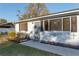 Cozy single-story home with a grey front door and decorative ironwork at 10495 Sw 100Th Ave, Ocala, FL 34481