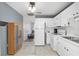 Bright kitchen with updated appliances, white cabinets, and easy access to the adjacent living area at 10495 Sw 100Th Ave, Ocala, FL 34481