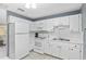 Bright kitchen with white appliances and cabinets with plenty of counter space at 10495 Sw 100Th Ave, Ocala, FL 34481