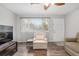 Bright living room featuring hardwood floors, large window with blinds and comfortable seating at 10495 Sw 100Th Ave, Ocala, FL 34481