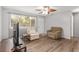 Bright living room featuring hardwood floors, large window and comfortable seating at 10495 Sw 100Th Ave, Ocala, FL 34481