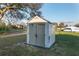 Backyard shed featuring neutral siding, and a light-colored roof, providing storage for outdoor equipment at 10495 Sw 100Th Ave, Ocala, FL 34481