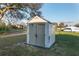The backyard features a storage shed with double doors and a well-maintained lawn at 10495 Sw 100Th Ave, Ocala, FL 34481