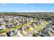 Aerial view of homes in a neighborhood surrounded by lush greenery and scenic lakes at 11013 Se 169Th Pl, Summerfield, FL 34491