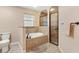 This bathroom showcases tile flooring, a soaking tub with tiled surround, and a separate glass-enclosed shower at 11013 Se 169Th Pl, Summerfield, FL 34491